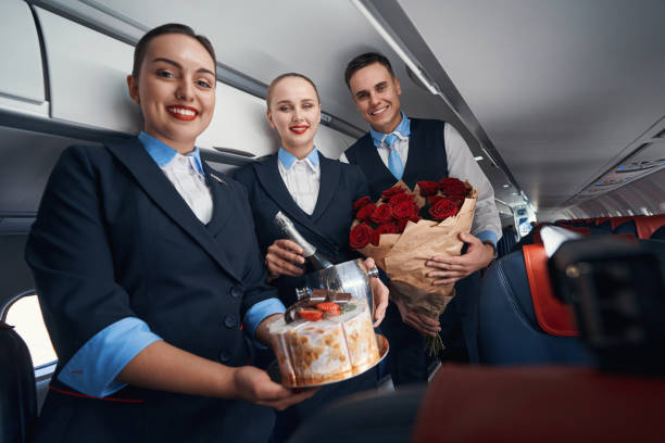 istock Joyful cabin attendants smiling at camera with presents 1357625021