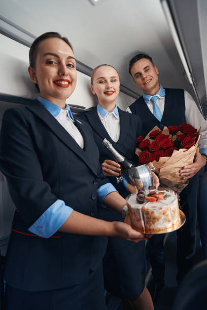istock Welcoming flight attendants posing for camera with birthday presents 1357625025