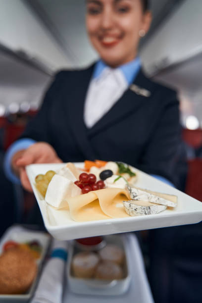 istock Flight attendant handing out plate with breakfast 1357625117