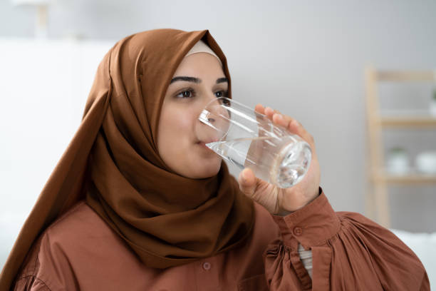 istock Thirsty Muslim Woman Drinking Clean Water 1357626418