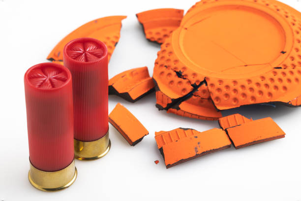 istock Shotgun bullet and broken clay target shooting on white background , Shooting game 1357627080