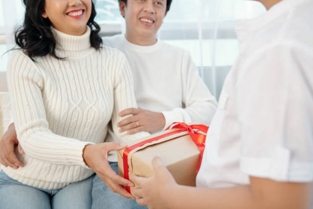 istock Child Giving Present to Parents 1357627267