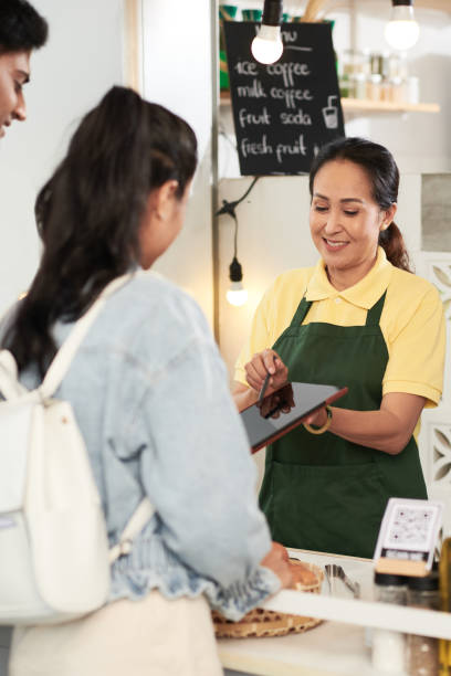 istock Vendor Showing Menu to Customers 1357628407