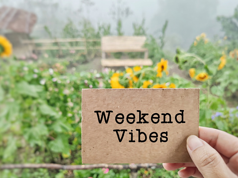 Weekend vibes text background. Stock photo.