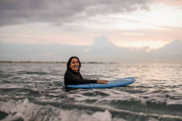 istock Female Barcelona Surfer In Water At Sunset 1357629606