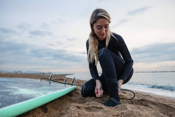 istock Female Surfer Attaching Safety Leash To Her Ankle 1357629610