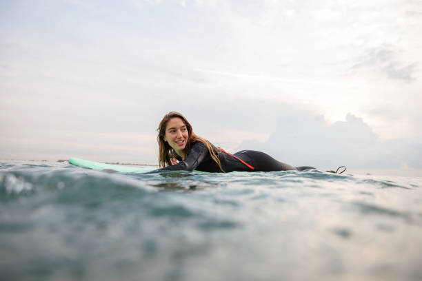 istock Female Surfer Paddling To Catch A Wave 1357629672