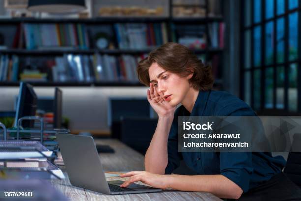 Caucasian Young Businesswoman Is Working Hard Overtime At Late Night To Meet The Task Deadline With Serious Face And Headache For Business And Education Concept Stock Photo - Download Image Now