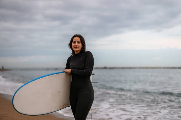 istock Barcelona Female Surfer Holding Her Board 1357629808