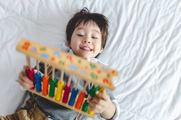 istock little boy playing toy ,Cognitive skills, Learning tools creativity ,Educational concept. 1357630783