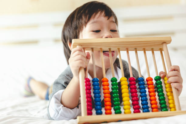 istock little boy playing toy ,Cognitive skills, Learning tools creativity ,Educational concept. 1357630784