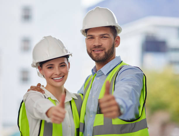 istock Cropped portrait of two young construction workers giving thumbs up while standing on site outside 1357632174