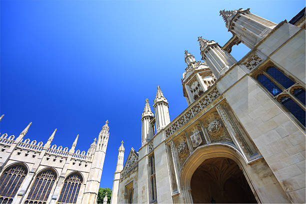View of Kings College looking up towards the sky Shot capturing King's College's Chapel and Front Gate cambridge england stock pictures, royalty-free photos & images