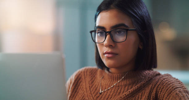 istock Shot of a young woman using a laptop while studying at home 1357635655