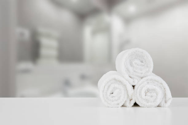 istock Stacked white spa towels on table against blurred background 1357636731