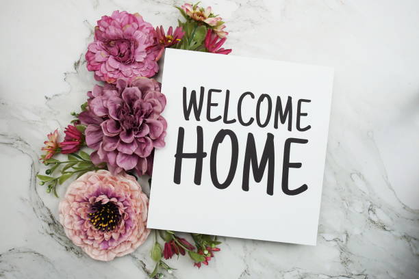 istock Welcome Home text with pink flower bouquet on marble background 1357637005