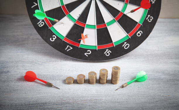 istock Coins and target dartboard. Business strategy. 1357637071