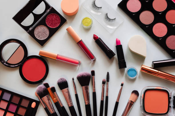 istock Set cosmetics and brushes light background. view top 1357637867