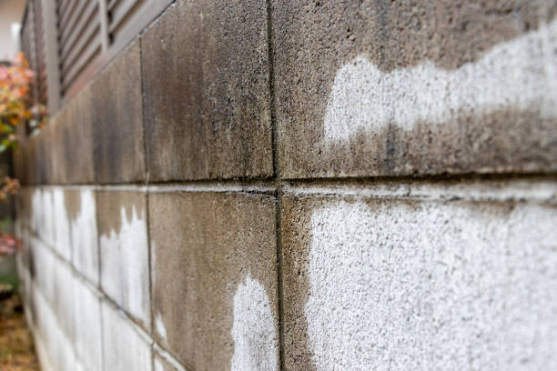 istock Concrete block wall partially wet by rain 1357638062
