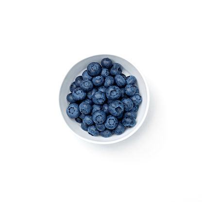 Blueberry in bowl isolated on white background. Copy space. Top view. High quality photo