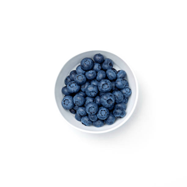 Blueberry in bowl isolated on white background. Copy space. Top view. stock photo