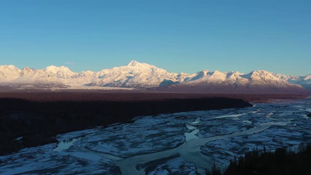 Mount Denali and Chulitna River in Winter at Sunrise. Alaska, USA. Aerial View