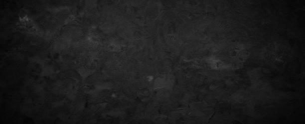 istock Black or dark gray rough grainy stone texture background 1357642963