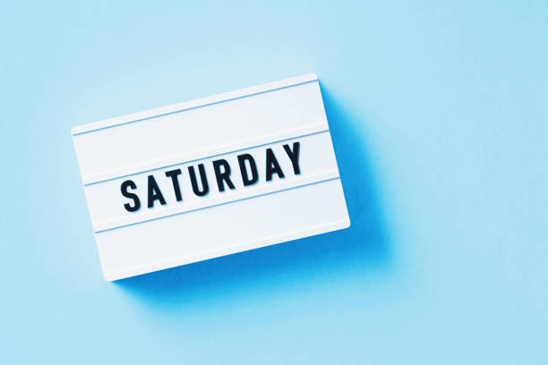 istock Saturday Reads Over White Lightbox Sitting On Blue Background 1357644121