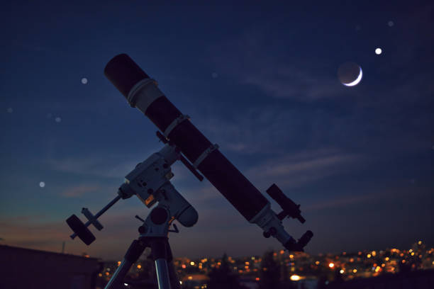 istock Astronomical telescope under a city twilight sky ready for stargazing. 1357645637