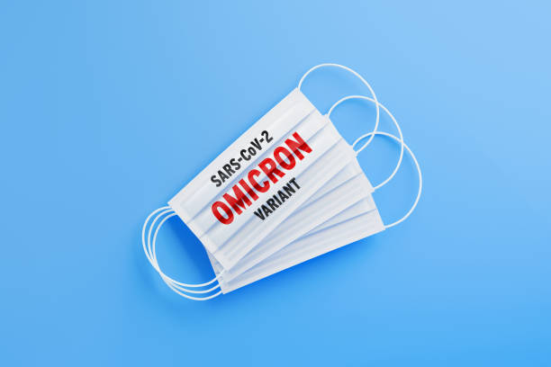 istock SARS-CoV-2 Omicron Variant Reads On White Protective Mask Over Blue Background 1357645641