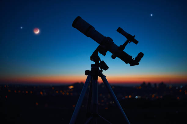 istock Astronomical telescope under a twilight sky ready for stargazing. 1357645648