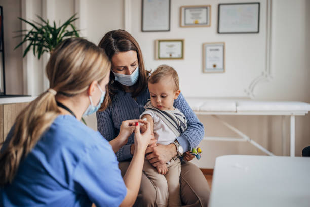 Little boy getting vaccinated stock photo