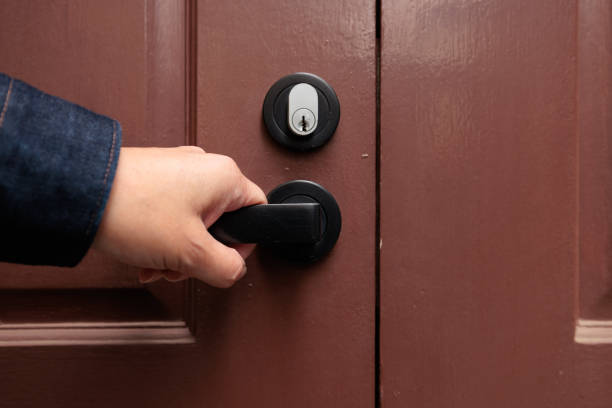 istock Woman's hand opening a brown door 1357646024