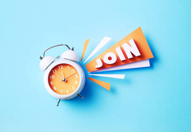 istock Join Reads Next To A White Alarm Clock On Blue Background 1357646620