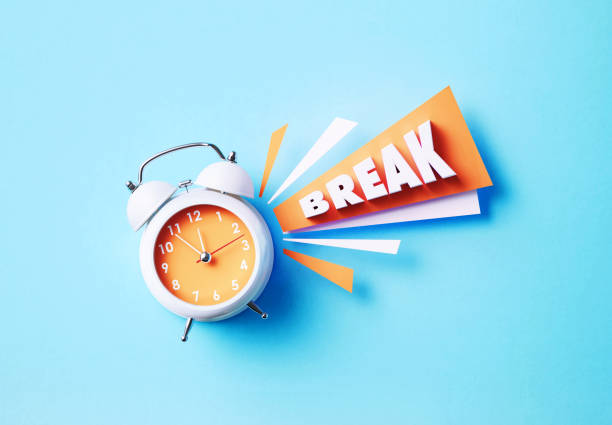 istock Break Reads Next To A White Alarm Clock On Blue Background 1357646698