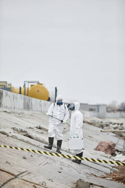 istock Two People at Industrial Disaster Site 1357646728