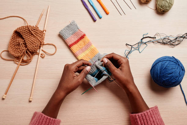 istock Female Hands Knitting Top View 1357647076