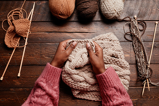 Female Hands Knitting on Wood