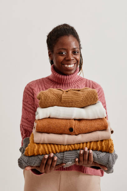 istock Woman Holding Knit Sweaters 1357647113