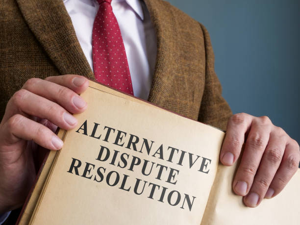 istock Lawyer shows ADR alternative dispute resolution methods in the book. 1357648478