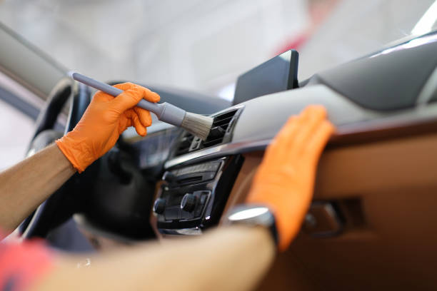 istock A man in a car wipes the dust with a brush 1357649774