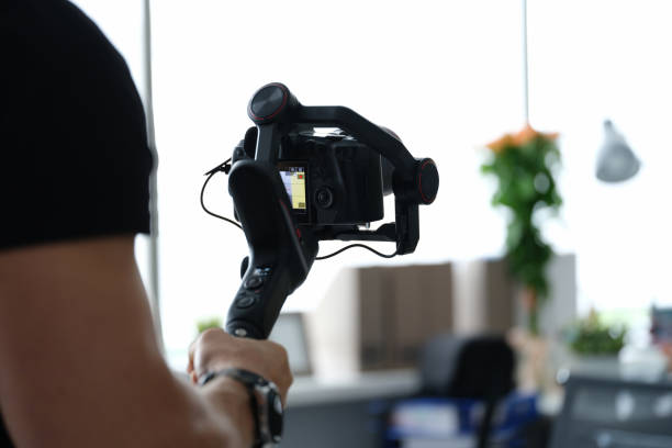 istock Male photographer holding steadicam and camera 1357649780