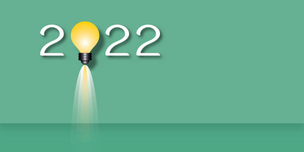 istock Light bulb in the year 2022 on green background. Concept for innovative business vision. 1357650150