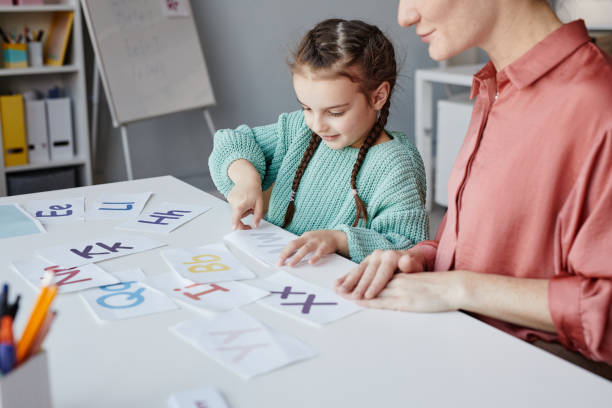 istock Little girl learning English at school 1357653727