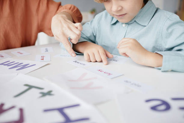 istock Boy learning to read in English 1357653742
