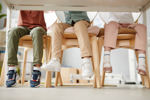 istock Children sitting at desk in the classroom 1357653758