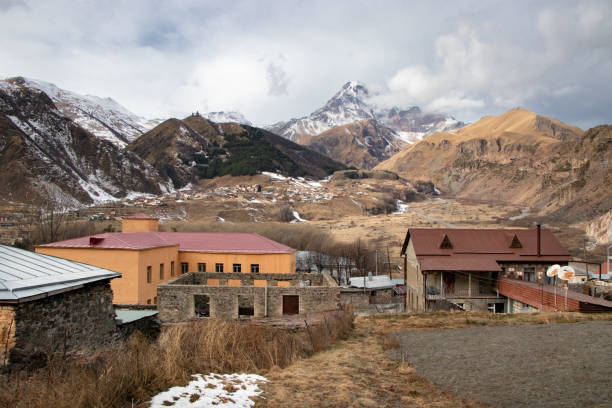 istock Georgian Village and Caucuses Mountains 1357654240