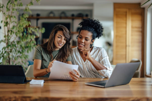 istock Two diverse coworkers, trying to interpret a contract 1357655192