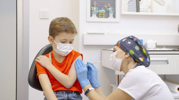 istock 9-year-old boy getting a COVID-19 vaccine 1357655559