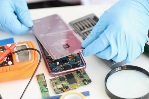 istock Male put back panel on mobile phone cover wire connections 1357655875